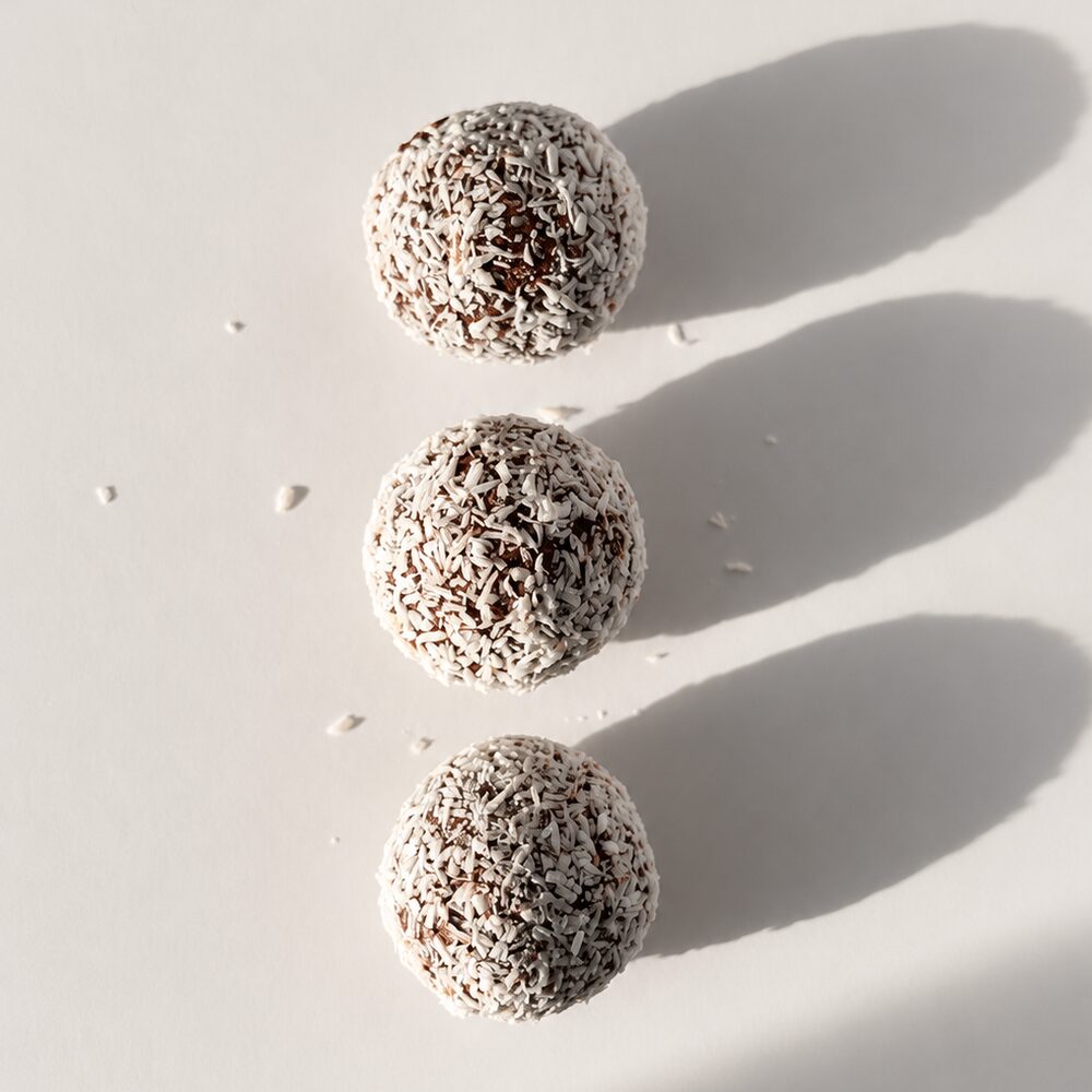 A BITEY protein chocolate truffle rolled in shredded coconut