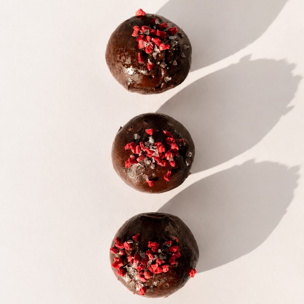 A BITEY protein chocolate in dark Belgian chocolate finished with freeze-dried berry pieces